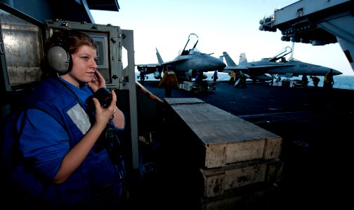 US Navy 111219-N-OY799-187 Airman Brittney Jeffery stands elevator operator watch as two aircraft are secured aboard the Nimitz-class aircraft carr