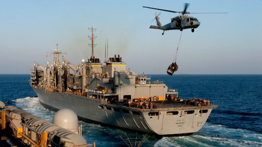 US Navy 111221-N-OY799-032 An MH-60S Sea Hawk helicopter from the Eightballers of Helicopter Sea Combat Squadron (HSC) 8 picks up stores from the f