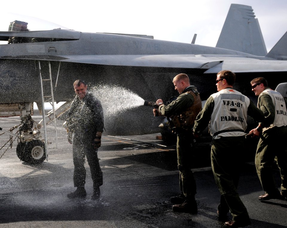 US Navy 111222-N-RG587-208 Cmdr. John Boone, commanding officer of Strike Fighter Squadron (VFA) 81, is hosed down after making his final landing a