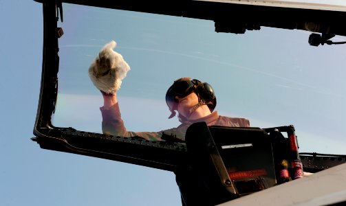 US Navy 111218-N-OY799-094 A Sailor wipes down the canopy of an aircraft on the flight deck of the Nimitz-class aircraft carrier USS John C. Stenni