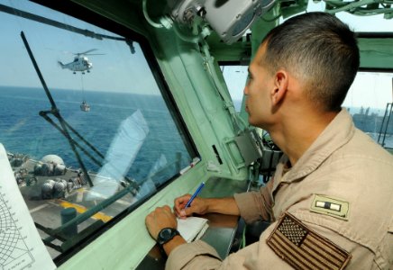 US Navy 111223-N-KA046-006 Chief Warrant Officer Robert Reyes takes notes during a vertical replenishment aboard the multipurpose amphibious assaul