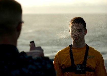 US Navy 111224-N-DR144-121 Mass Communication Specialist 3rd Class Aaron Shelley captures video footage from a camera mounted to his chest as he is
