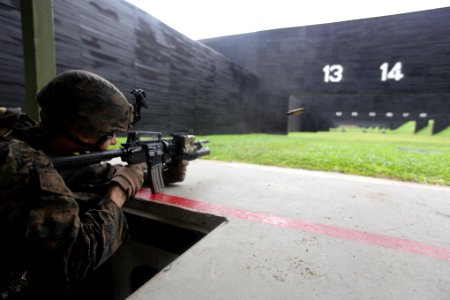 US Navy 111219-M-OO345-002 Cpl. Ryan Caldwell, assigned to the 11th Marine Expeditionary Unit (11th MEU), fires an M4 rifle during a live-fire exer