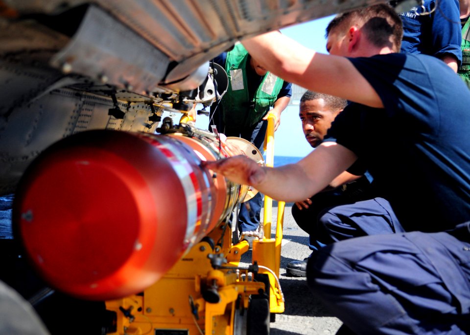 US Navy 111222-N-ZF681-031 Sailors aboard the guided-missile destroyer USS Halsey (DDG 97) load a MK-46 recoverable exercise torpedo (REXTORP) onto