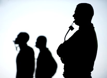 US Navy 111223-N-DR144-097 Senior Chief Aviation Boatswain's Mate Scott Doty supervises as Sailors assigned to Air Department's V-3 Division positi
