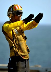 US Navy 120207-N-YB753-012 A Sailor directs aircraft during flight operations photo