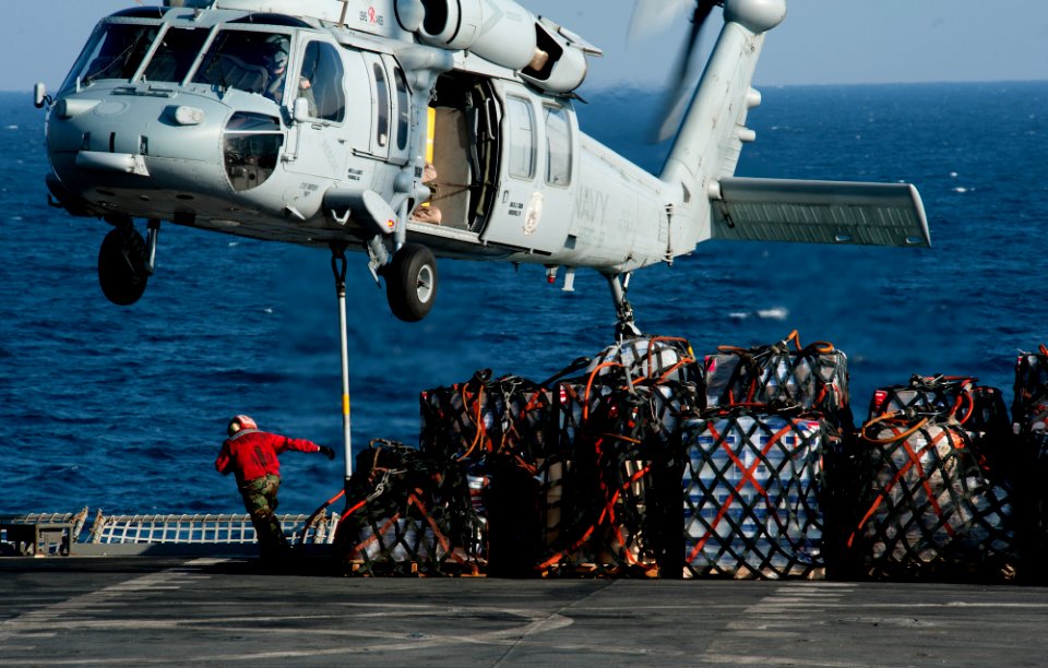 US Navy 111221-N-OY799-341 An MH-60S Sea Hawk helicopter from the Eightballers of Helicopter Sea Combat Squadron (HSC) 8 picks up stores