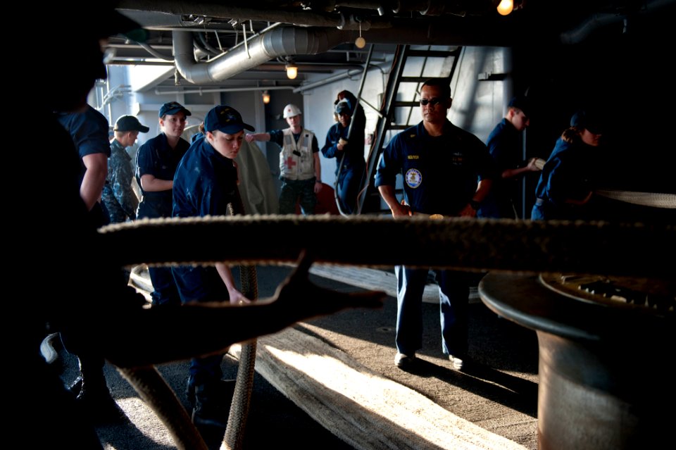 US Navy 111227-N-BT887-069 Sailors heave mooring lines during sea and anchor detail aboard the Nimitz-class aircraft carrier USS John C. Stennis (C