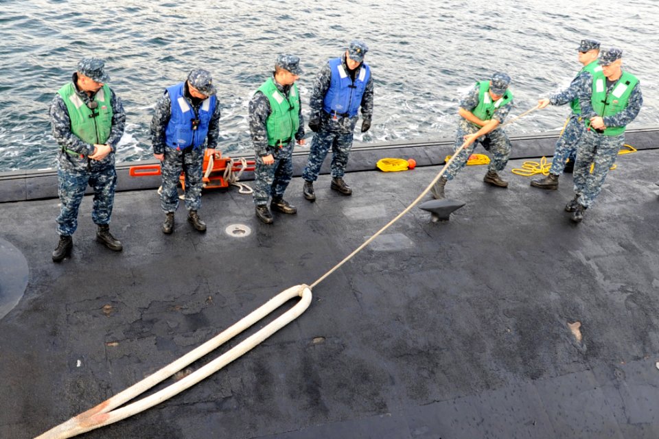 US Navy 111221-N-DI599-027 Sailors aboard USS North Carolina receive a line