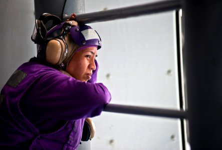 US Navy 111220-N-DX615-035 Aviation Boatswain's Mate (Fuels) 3rd Class Debra Rosario, watches the Military Sealift Command fleet replenishment oile