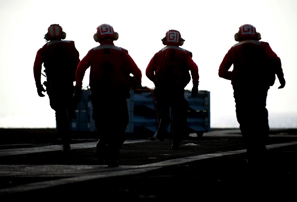 US Navy 111222-N-DR144-055 Aviation Ordnancemen assigned to Weapons Department's G-1 Division run to retrieve crates of ordnance aboard the Nimitz