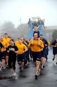 US Navy 111221-N-SN160-032 Seabees assigned to Naval Mobile Construction Battalion (NMCB) 74 and their families participate in an early morning phy