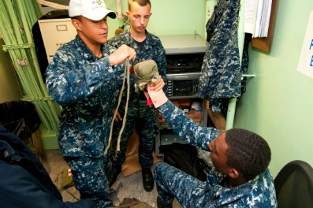 US Navy 111220-N-PB383-056 Hospital Corpsman 2nd Class Benoit Cisneros demonstrates how to properly bandage an amputee during a medical training te