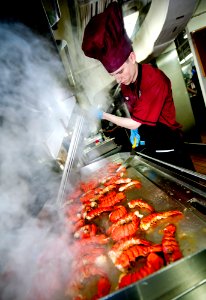 US Navy 111220-N-OY799-224 Culinary Specialist Seaman Jon Ketola grills lobster tails in preparation for the Christmas meal in the aft galley aboar photo