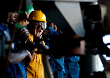 US Navy 111221-N-BT887-155 Boatswain's Mate 2nd Class Madeline Acosta, the rig captain, calls out speeds to a capstan operator aboard the Nimitz-cl