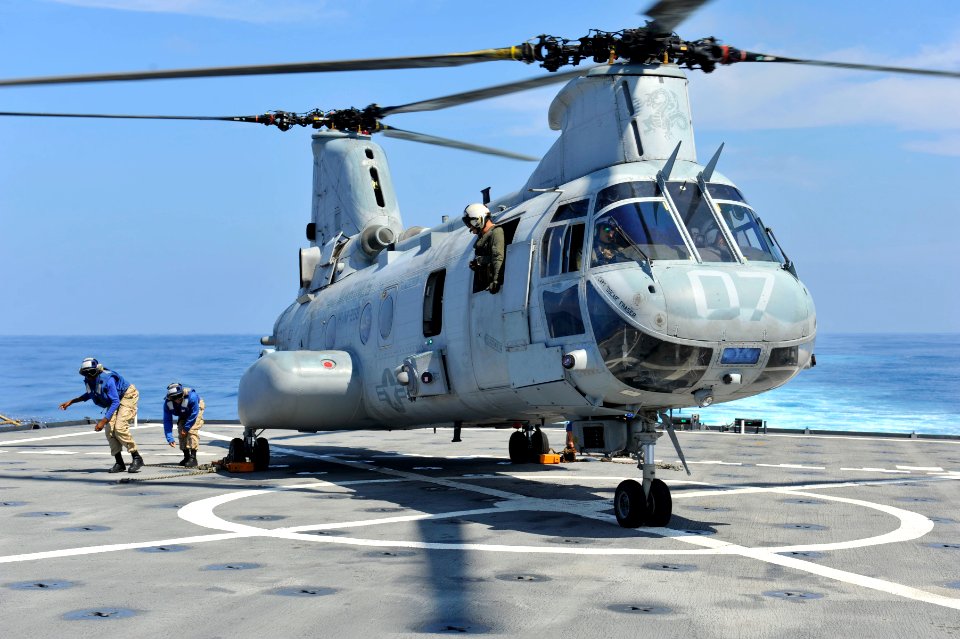 US Navy 111229-N-KS651-392 Sailors aboard the amphibious dock landing ship USS Pearl Harbor (LSD 52) secure a CH-46 Sea Knight helicopter