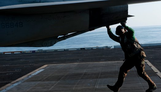 US Navy 111222-N-OY799-306 A Sailor checks the tail hook of an F-A-18F Super Hornet from the Black Aces of Strike Fighter Squadron (VFA) 41