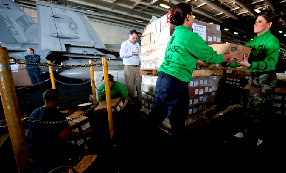 US Navy 111221-N-OY799-173 Sailors move cargo during a replenishment at sea aboard the Nimitz-class aircraft carrier USS John C. Stennis (CVN 74)