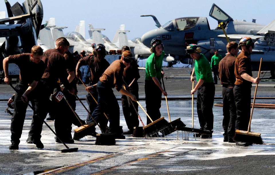 US Navy 111223-N-RG587-433 Sailors scrub the flight deck of the Nimitz-class aircraft carrier USS Carl Vinson (CVN 70)