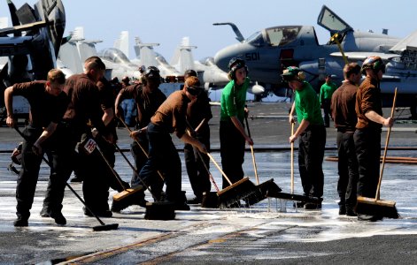 US Navy 111223-N-RG587-433 Sailors scrub the flight deck of the Nimitz-class aircraft carrier USS Carl Vinson (CVN 70)