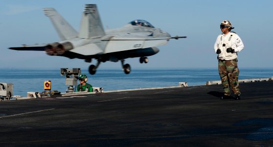 US Navy 111222-N-OY799-246 Sailors stand watch on the flight deck as an F-A-18F Super Hornet from the Black Aces of Strike Fighter Squadron (VFA) 4