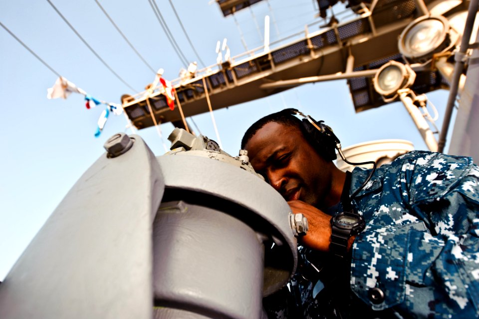 US Navy 111227-N-GC412-118 Quartermaster 3rd Class Clem Benton uses an alidade to shoot bearings aboard the Nimitz-class aircraft carrier USS John