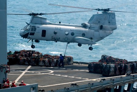 US Navy 111221-N-PB383-355 A CH-53E Super Stallion helicopter, assigned to Marine Medium Helicopter Squadron (HMM) 268 Reinforced, transfers cargo