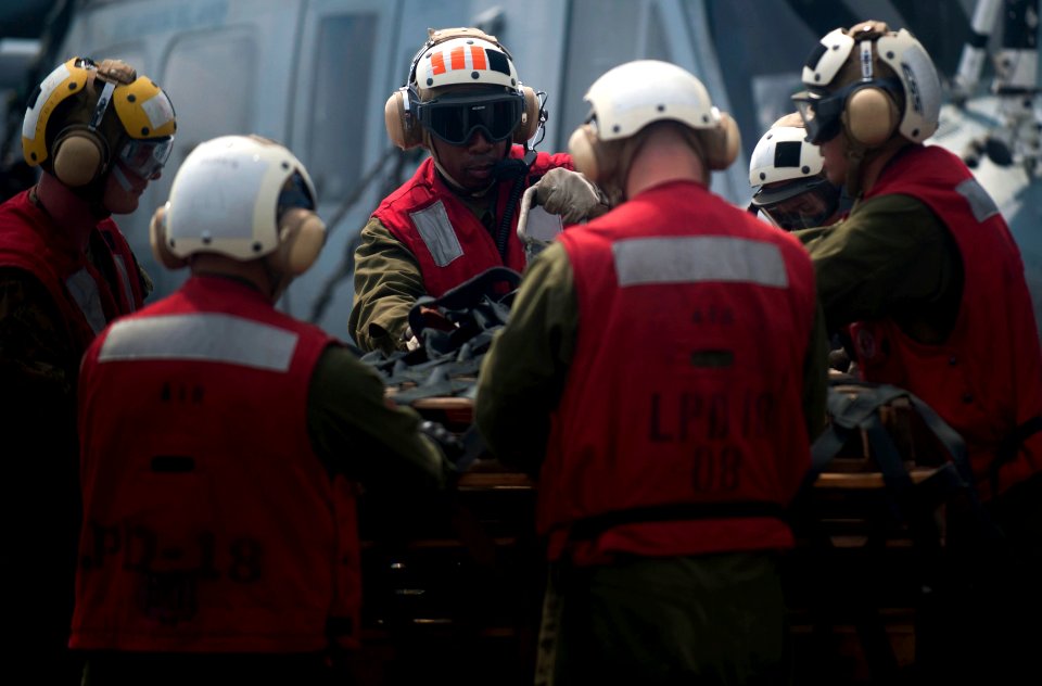 US Navy 111221-N-PB383-413 Marines assigned to the 11th Marine Expeditionary Unit (11th MEU) retrieve a cargo holder aboard the amphibious transpor