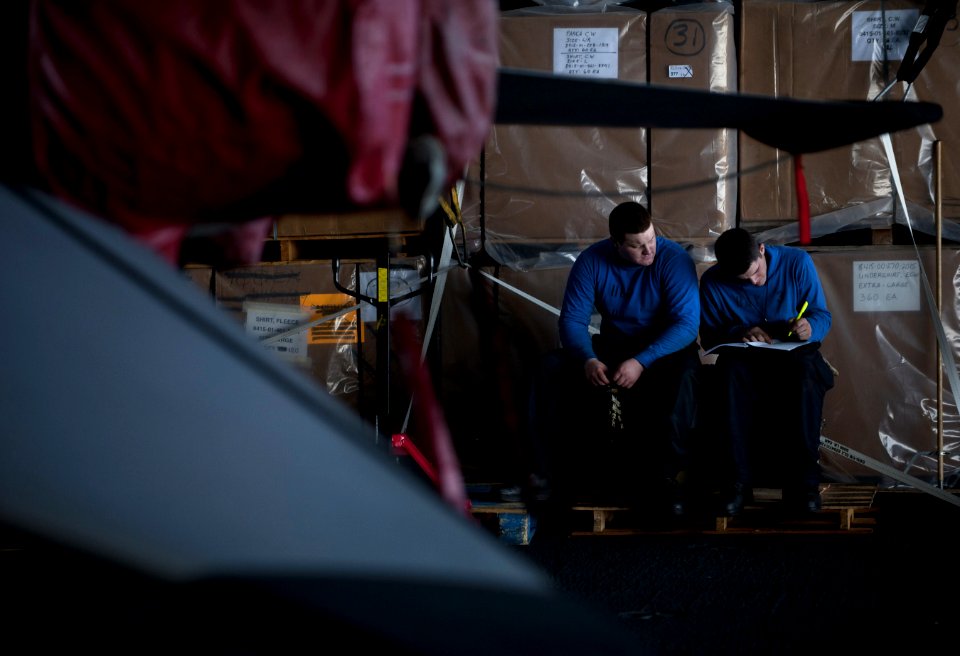 US Navy 111223-N-DR144-152 Airman Michael Laurion, right, and Airman Dylan Ulrich, both assigned to the Nimitz-class aircraft carrier USS Carl Vins