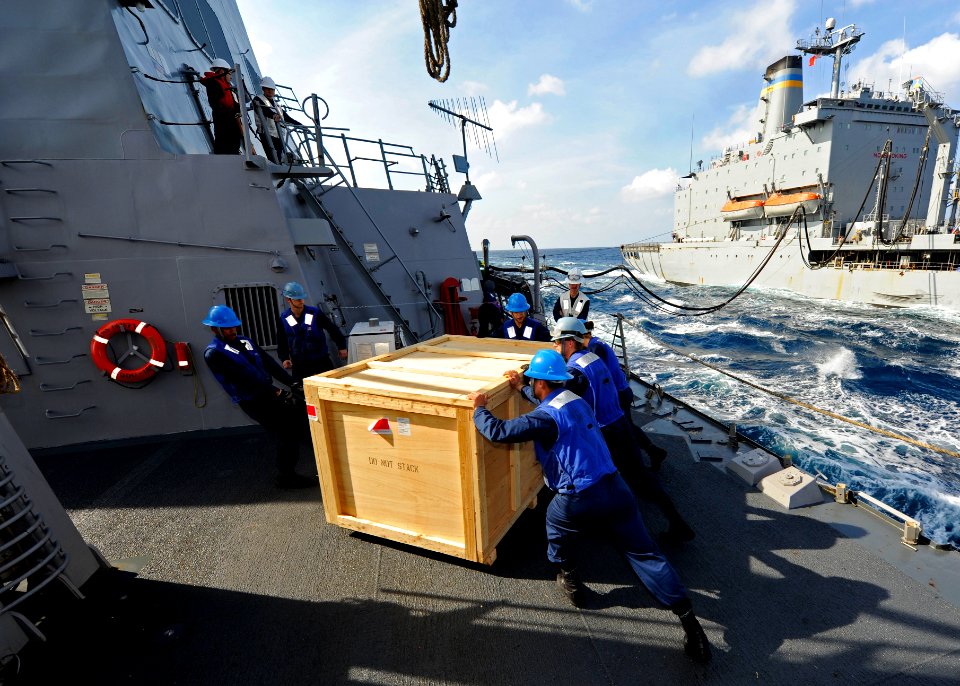US Navy 111221-N-VH839-022 Sailors aboard the Arleigh Burke-class guided-missile destroyer USS Dewey (DDG 105) remove a cargo box from the pallet l
