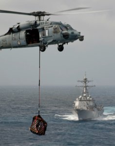 US Navy 120102-N-DR144-140 A helicopter delivers pallets during a vert replenishment at sea