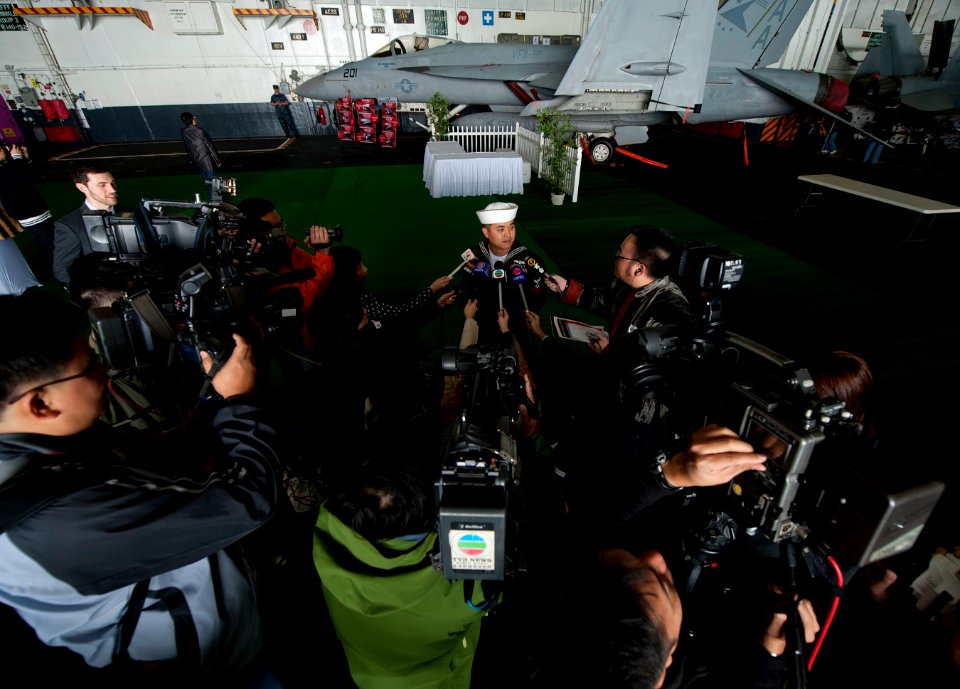 US Navy 111227-N-DR144-569 A Sailor speaks to members of the Hong Kong press.