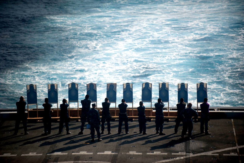 US Navy 111229-N-PB383-537 Sailors conduct a small-arms live-fire exercise aboard the amphibious transport dock ship USS New Orleans (LPD 18)