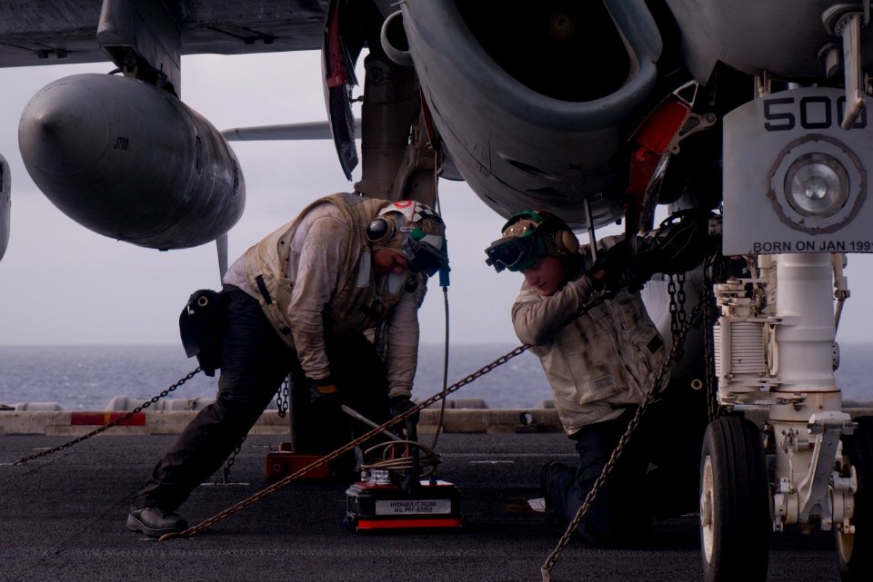 US Navy 111231-N-TZ605-629 Aviation Electronics Machinist's Mate 3rd Class Norman Fernandez, left, and Aviation Structural Mechanic 3rd Class Matth