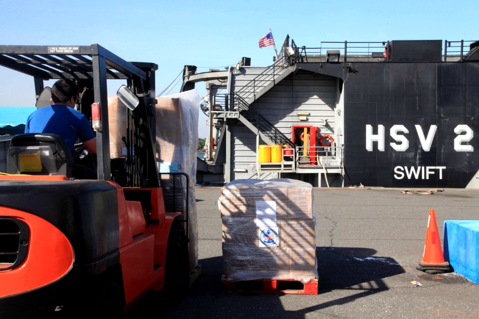 US Navy 120103-A-IP644-040 Donated goods are offloaded from High Speed Vessel (HSV 2) Swift for Project Handclasp during HSV-Southern Partnership S