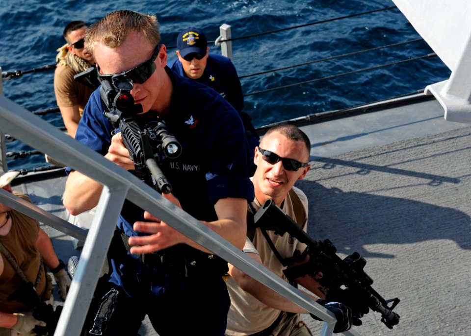 US Navy 111228-N-VH839-032 Fire Controlman 2nd Class Matthew Burger leads a team of Sailors and U.S. Coast Guardsmen to a higher position during a