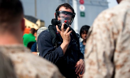 US Navy 120105-N-PB383-842 A Sailor demonstrates how to properly wear fire fighting equipment