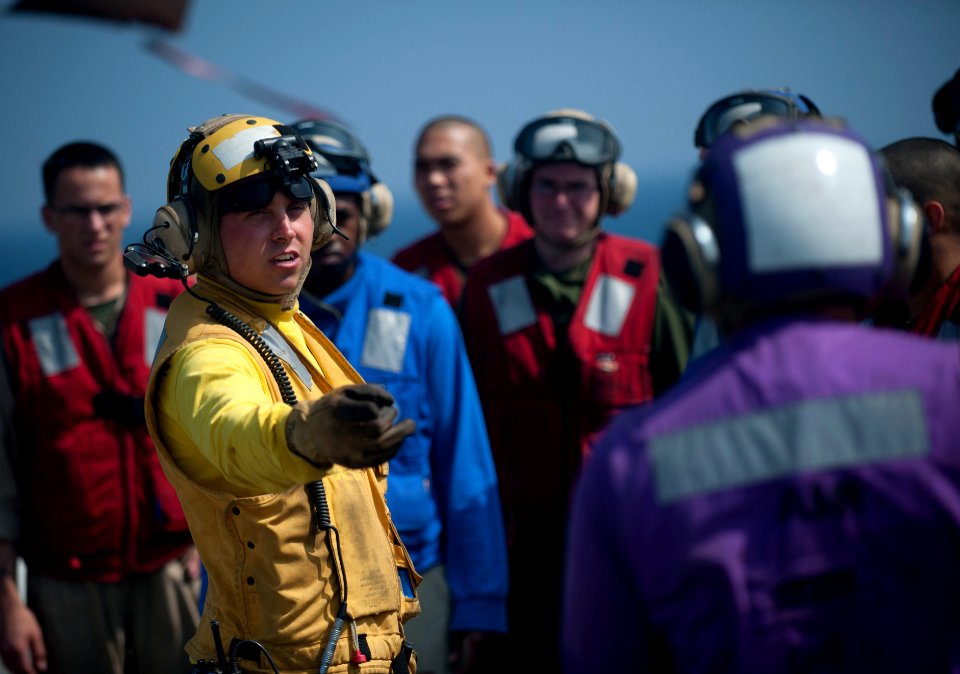 US Navy 120103-N-PB383-286 Aviation Boatswain's Mate (Handling) 2nd Class Mark Thornton addresses Sailors and Marines during a flight deck fire fig