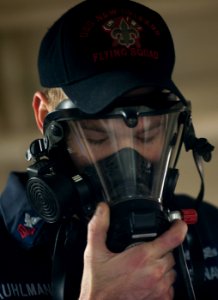 US Navy 120124-N-PB383-163 Damage Controlman 1st Class Justin Kuhlman demonstrates how to properly don a breathing apparatus