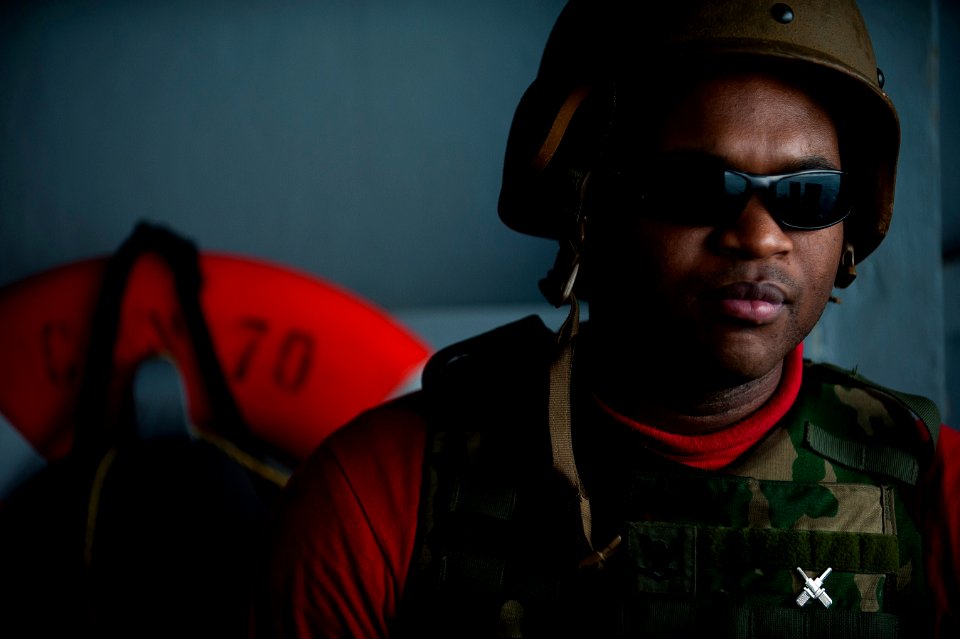 US Navy 120103-N-DR144-101 Gunner's Mate 3rd Class Anthony Crutchfield mans a .50-caliber machine gun mount during a crew-served weapons fire exerc