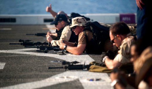 US Navy 111231-N-PB383-320 Chief Fire Controlman Bronson Ryan, assigned to the visit, board, search, and seizure team, loads ammunition into his M1