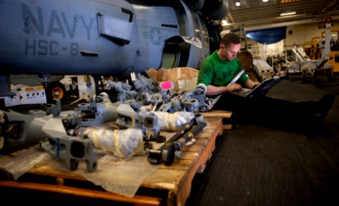 US Navy 111229-N-OY799-024 Aviation Structural Mechanic 3rd Class Chad Swaner, from Wylie, Texas, performs a 700-hour inspection on an MH-60S Knigh