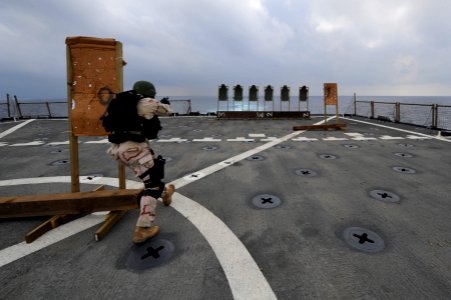 US Navy 120101-N-KS651-688 Senior Chief Master-at-Arms Robert Goode navigates a course on the flight deck of the amphibious dock landing ship USS P