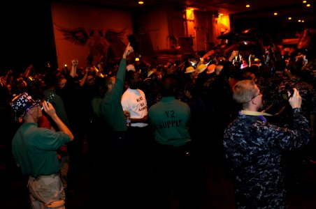 US Navy 120101-N-RG587-108 Sailors assigned to the Nimitz-class aircraft carrier USS Carl Vinson (CVN 70) celebrate in the hangar bay during a mora photo