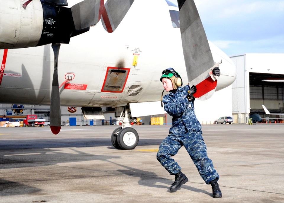 US Navy 111228-N-PP197-042 Aviation Machinist's Mate Airman Sarah Rutledge inspects propeller number four for damage as part of a daily inspection