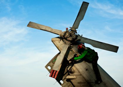US Navy 120105-N-BT887-644 Airman Joyce Cruz secures a tail rotor of an MH-60R Sea Hawk helicopter from the Raptors of Helicopter Maritime Strike S