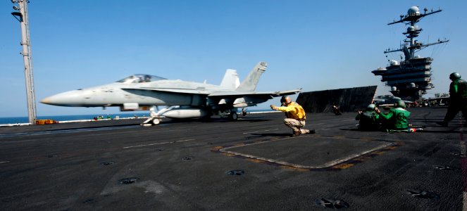 US Navy 120104-N-OY799-100 An F-A-18C Hornet from the Golden Dragons of Strike Fighter Squadron (VFA) 192 launches from the Nimitz-class aircraft c