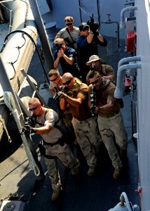 US Navy 111228-N-VH839-028 Sailors and Coast Guardsmen practice clearing the weather decks during training