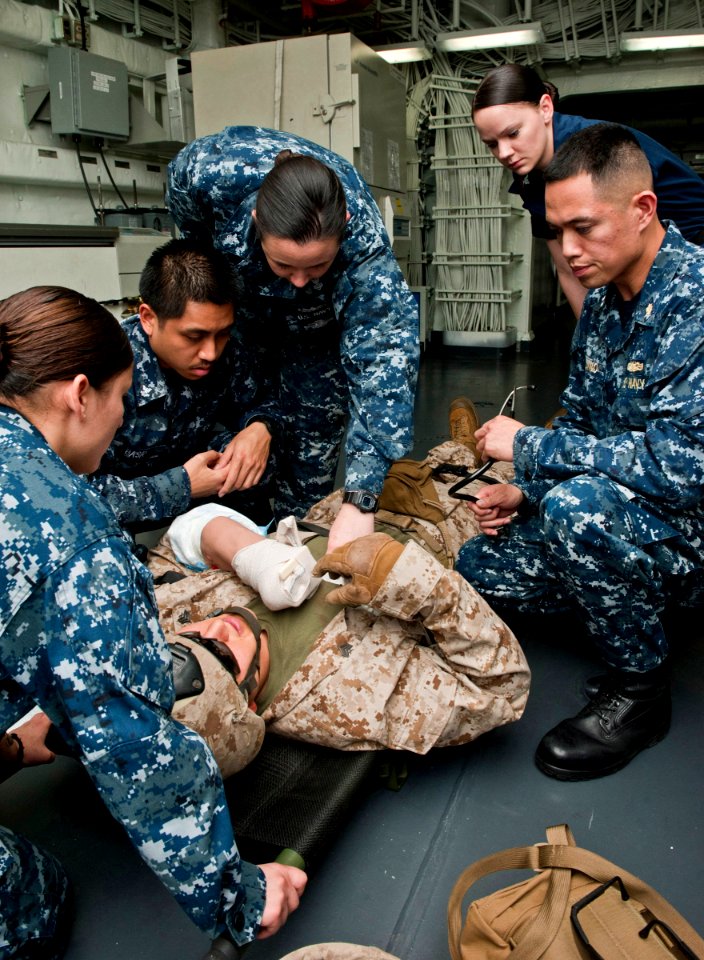 US Navy 120105-N-DX615-016 Medical personnel evaluate a simulated patient during a medical evacuation drill aboard the amphibious assault ship USS