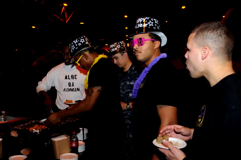 US Navy 120101-N-RG587-009 Sailors assigned to the Nimitz-class aircraft carrier USS Carl Vinson (CVN 70) serve themselves food in the hangar bay d